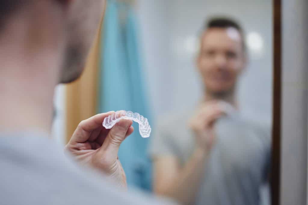 man holding invisalign